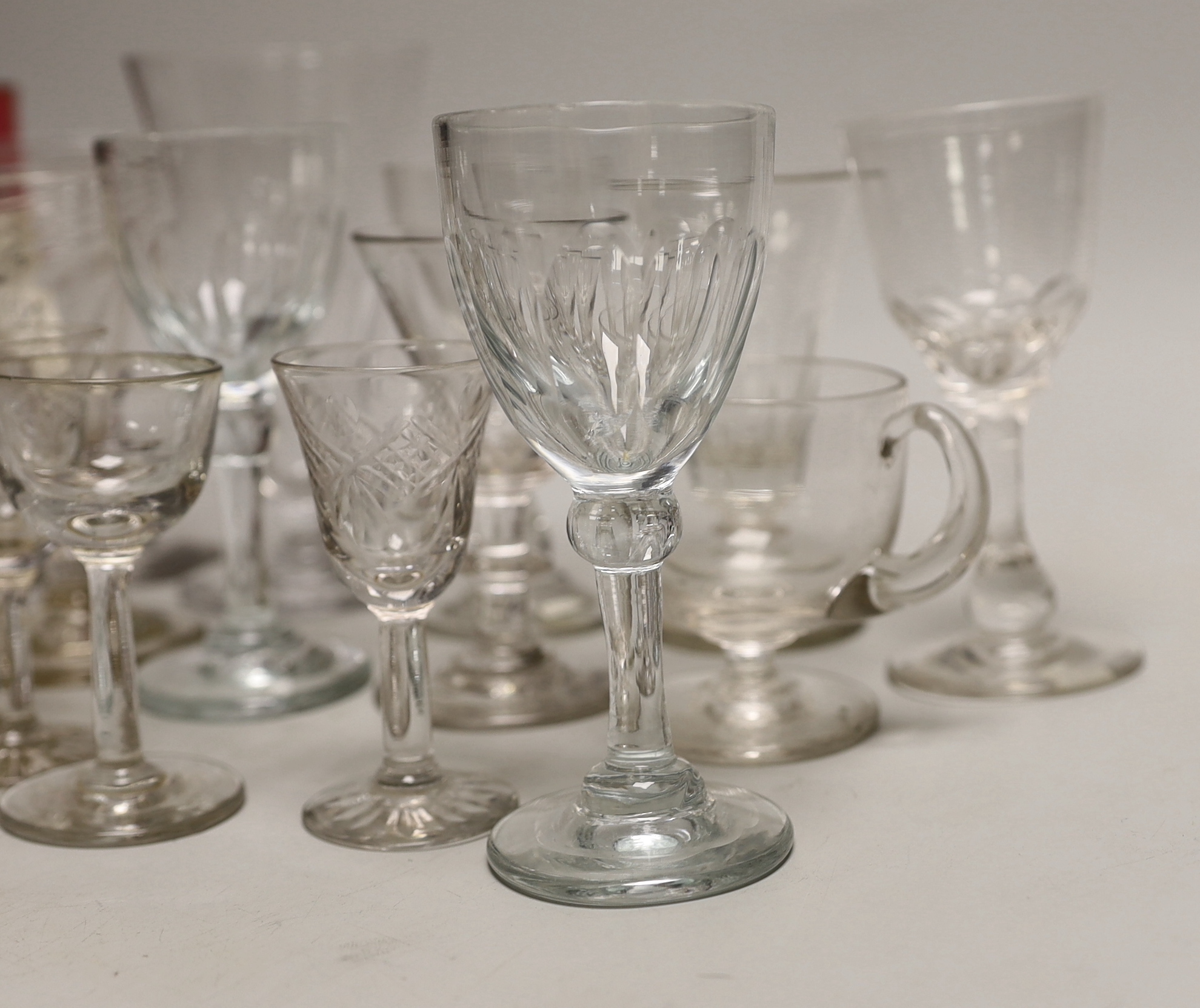 A quantity of antique and later glasses including a Georgian dwarf ale glass and Victorian cranberry example the largest 14cm high